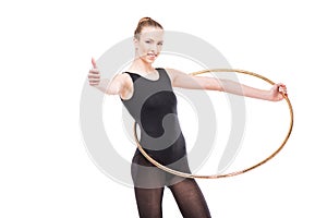 Attractive rhythmic gymnast in leotard with hoop showing thumb up