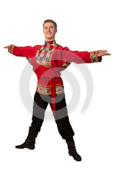 Attractive russian guy dancing in folk costume isolated on white