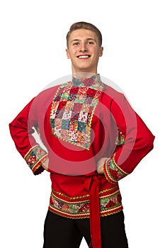 Attractive russian guy dancing in folk costume isolated on white