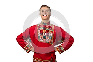 Attractive russian guy dancing in folk costume isolated on white