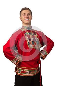 Attractive russian guy dancing in folk costume isolated on white