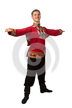 Attractive russian guy dancing in folk costume isolated on white