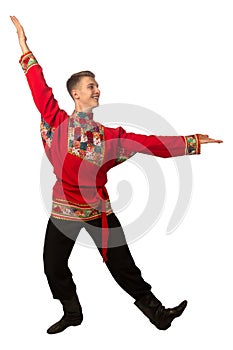 Attractive russian guy dancing in folk costume isolated on white