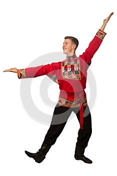 Attractive russian guy dancing in folk costume isolated on white