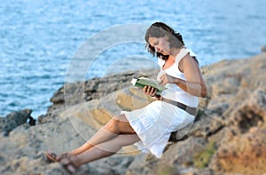 Attractive 40s mature woman reading and looking at horizon pensive