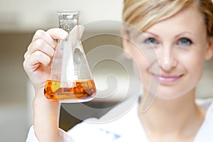 Attractive scientist showing an erlenmeyer