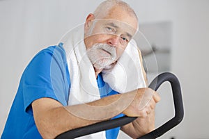 attractive senior man at health club exercising on stepper