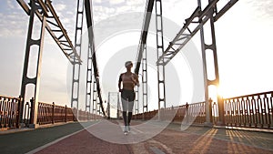 Attractive senior woman jogging on bridge