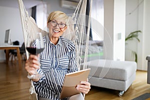 Attractive senior woman using a tablet computer relaxing at home