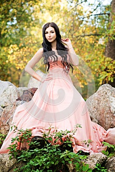 Attractive sensual woman in pink dress. Autumn, fall