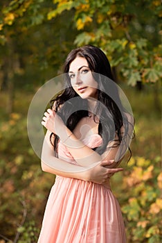 Attractive sensual woman in pink dress. Autumn, fall