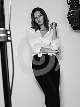 Attractive Sensual Woman is Posing in White Shirt. Black and White Cinematic Portrait with Cute Emotions