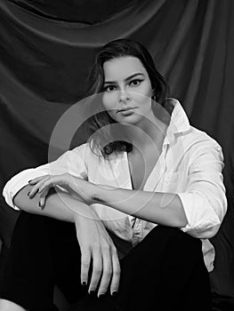 Attractive Sensual Woman is Posing in White Shirt. Black and White Cinematic Portrait with Cute Emotions