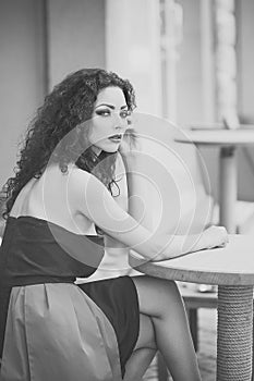 Attractive sensual young woman sitting at table