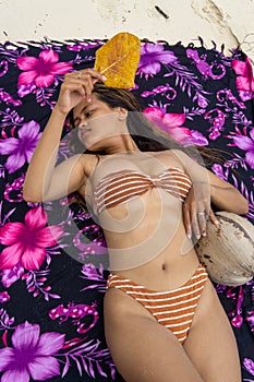 Attractive sexy Indonesian woman posing on the beach in Sulawesi, Togian Islands