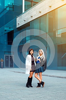 Attractive ladies brunette and blonde looking at the camera