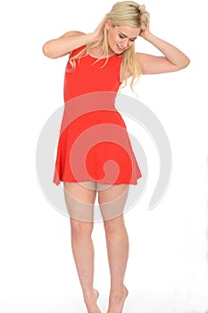 Attractive Playful Young Blonde Woman Wearing a Short Red Mini Dress