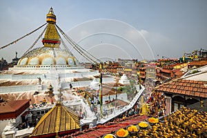 Attractive shot of Boudhanath Stupa temple dome worshipers lighted candles prayer flags Nepal