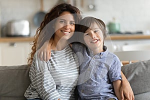 Attractive single mother posing for family photo with son.