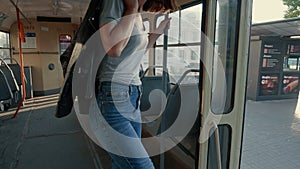 Attractive single young female exiting an old tram in slow-motion.