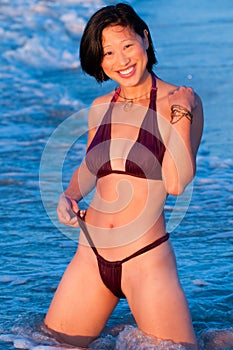 Attractive smiling Asian woman in bikini