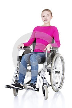 Attractive smiling disabled woman sitting in a wheel chair