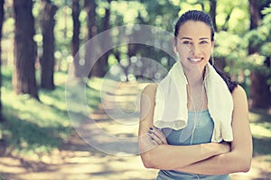 Attractive smiling fit woman with white towel resting after workout