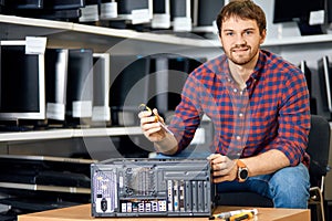 Attractive smiling man holding a screwdriver