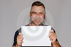 Attractive smiling middle-aged man holding a sign