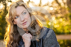 Attractive Smiling Middle Aged Woman Outside in Sunshine