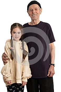 Attractive smiling old man in black hat, t-shirt and white wireless headphones, senior pencioner looking at the camera