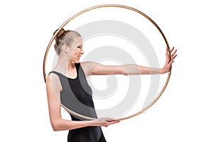 Attractive smiling rhythmic gymnast in leotard posing with hoop