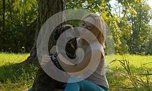 Attractive smiling woman hugging her nice dog