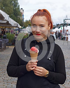 Attractive smiling woman with ice cream.