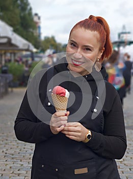 Attractive smiling woman with ice cream.