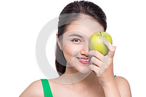 Attractive smiling young asian woman eating green apple isolated