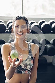 Attractive smiling young asian woman holding  green apple to eat. Healthy concept