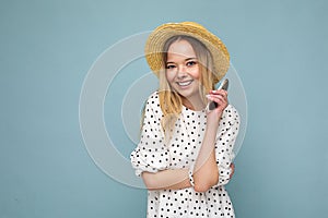 Attractive smiling young blonde woman wearing everyday stylish clothes and modern sunglasses isolated on colorful