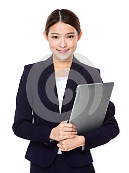 Attractive smiling young business woman holding laptop computer