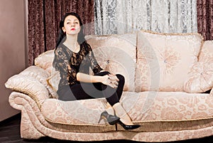 Sophisticated woman posing on a sofa