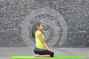 Attractive spiritual young woman doing yoga
