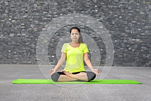 Attractive spiritual young woman doing yoga