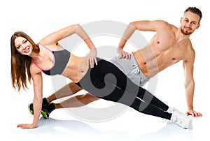 Attractive sport couple - man and woman doing fitness exercises