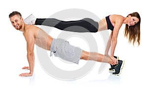 Attractive sport couple - man and woman doing fitness exercises