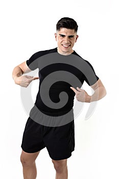 Attractive sport man pointing on his black t-shirt with copy space for adding gym fitness health club logo