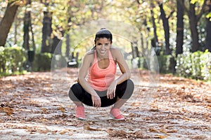 Attractive sport woman in runner sportswear taking a break tired smiling happy and cheerful after running workout