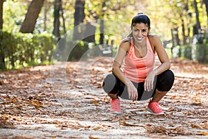 Attractive sport woman in runner sportswear taking a break tired smiling happy and cheerful after running workout