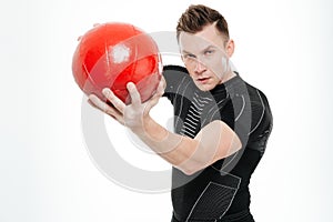 Attractive sportive man doing exercises with heavy fitness ball