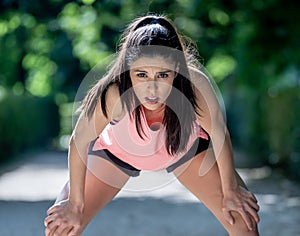 attractive sports woman runner taking a break feeling tired afte