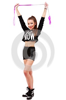 Attractive sporty woman posing holding a skipping rope on white